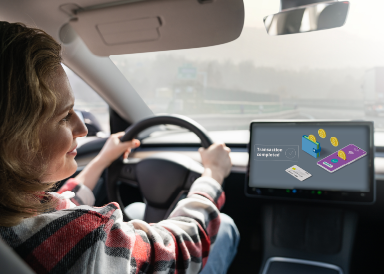 A woman making payments using a digital wallet integrated into the connected car